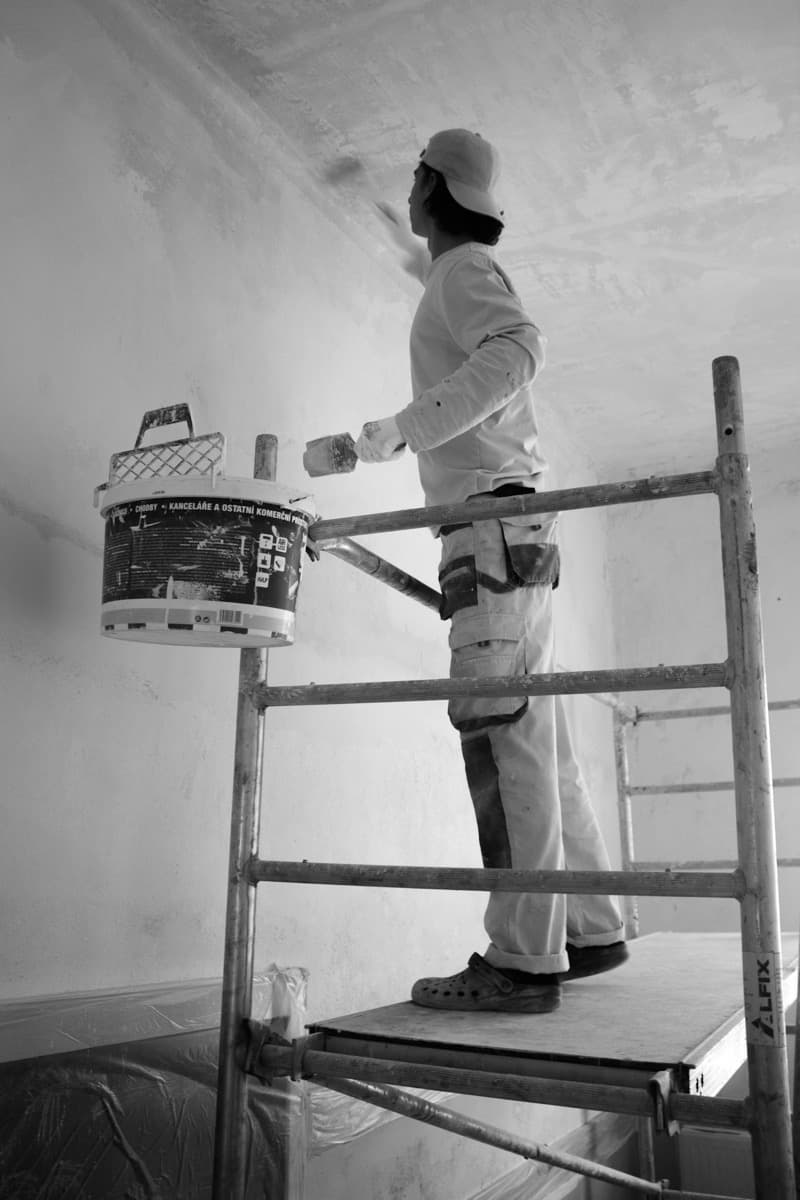 Decorator preparing a wall